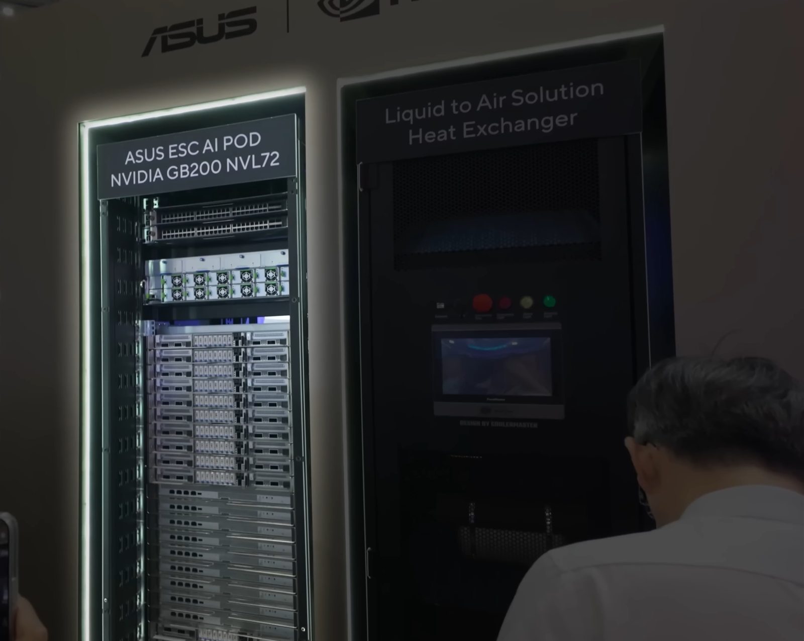 An NVIDIA GB200 NVL72 rack system on display beside a liquid-to-air heat exchanger cabinet.
